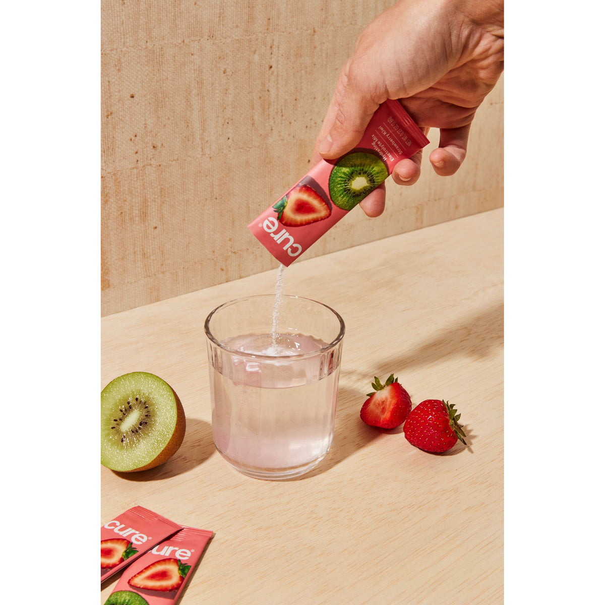Cure Hydration Strawberry Kiwi single-serving packet poured into water